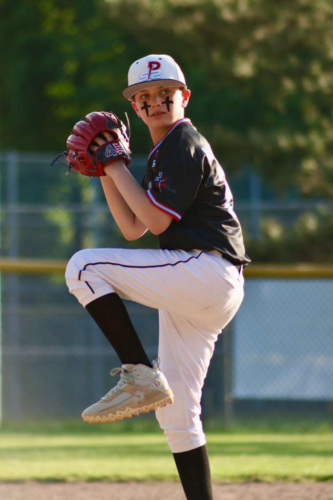 Pitcher in the windup with eye black crosses
